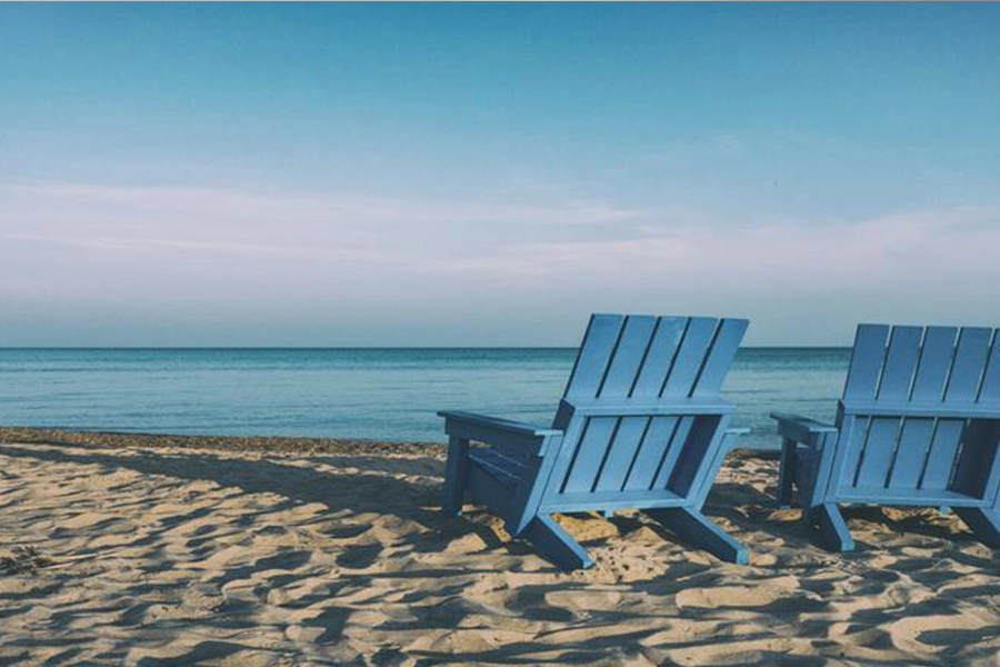 Two turquoise blue antique beach chairs made of wood