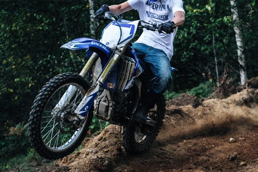 Man rocking tough denim pants riding in the woods