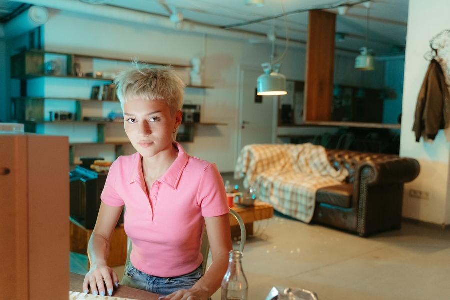 Blonde hair lady in pink polo shirt with blue jeans