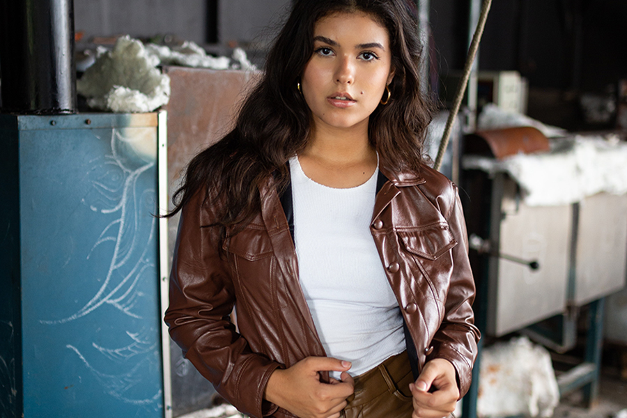 Lady in brown Perfecto jacket and white top