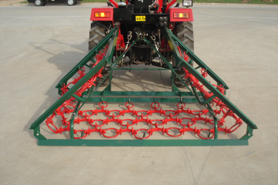 A chain harrow attached to a tractor