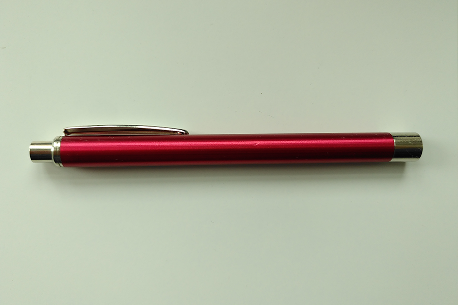 Red pen light against green background