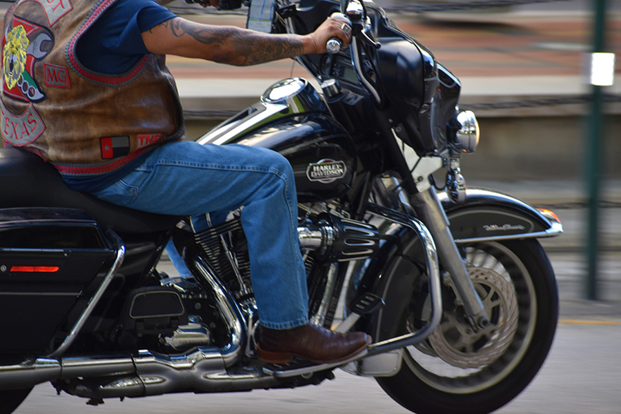 Big man with tattoo wearing brown biker vest