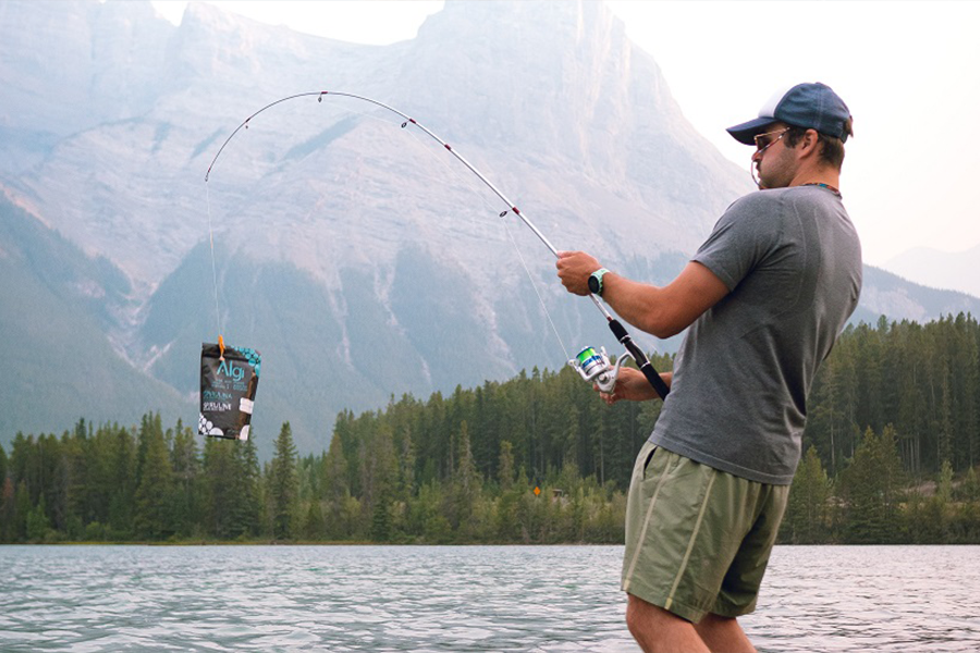 Angler in grey fishing shorts and a base layer T-shirt