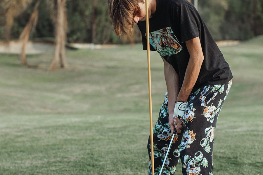 Young man wearing black slogan tee with design-print pants