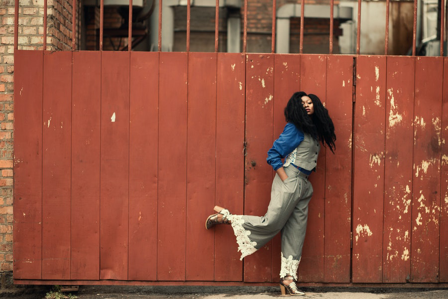 Woman rocking grey vest and pants with white lace embellishments