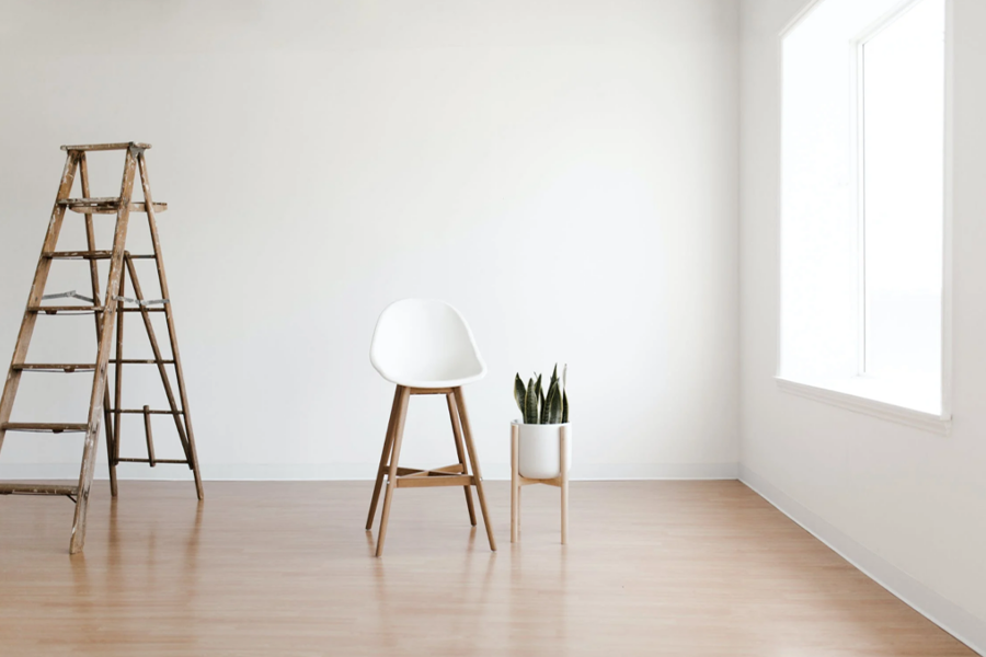 White round table near white wall on white oak floor