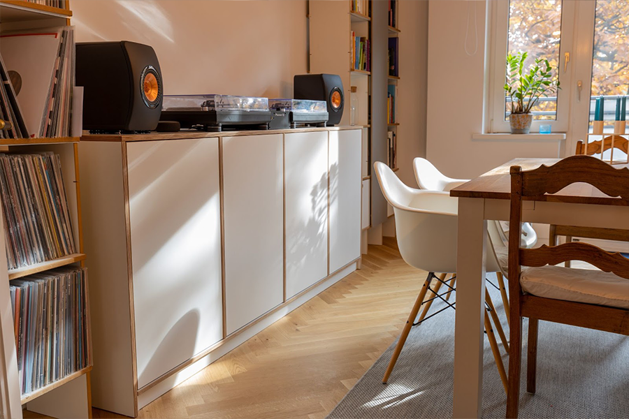 Light wood vinyl flooring in a dining room with white furniture