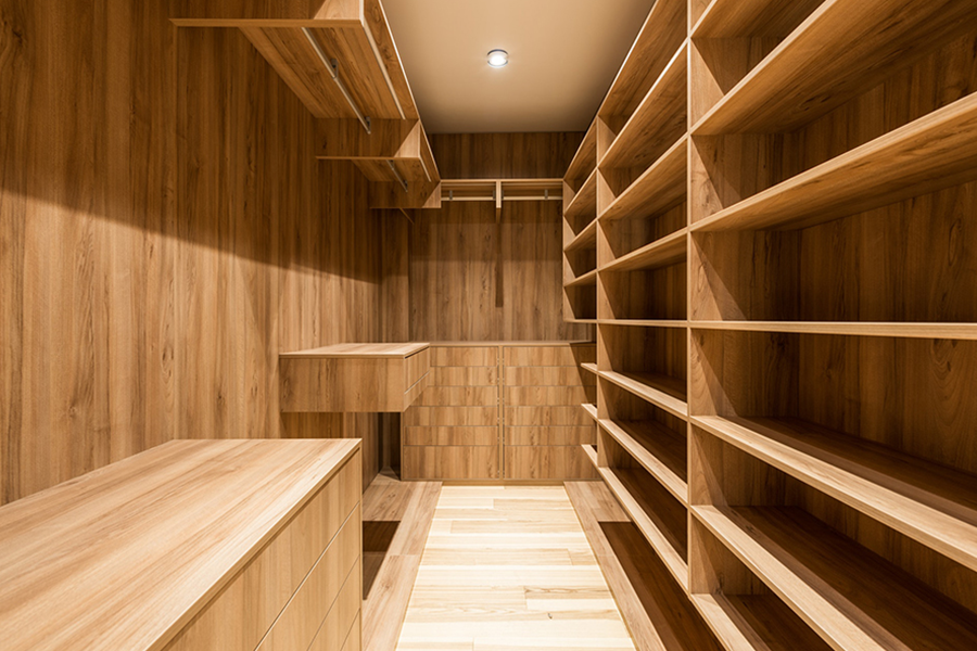 A light-brown walk-in closet and an LED ceiling light