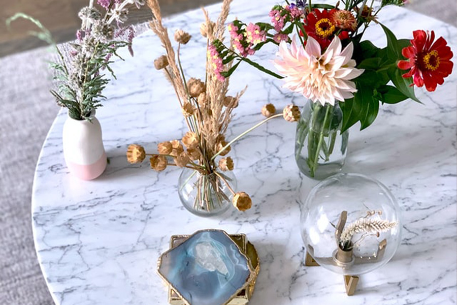 A Table With Three Vases And Two Showpieces