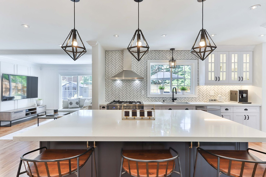 An Offwhite Kitchen Island With Three Chairs