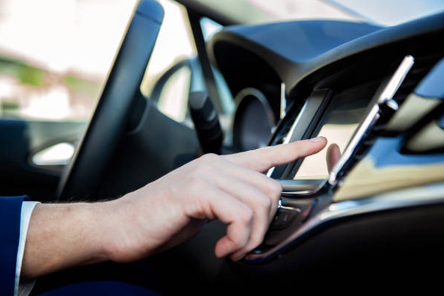 man using multimedia system built-in to a car