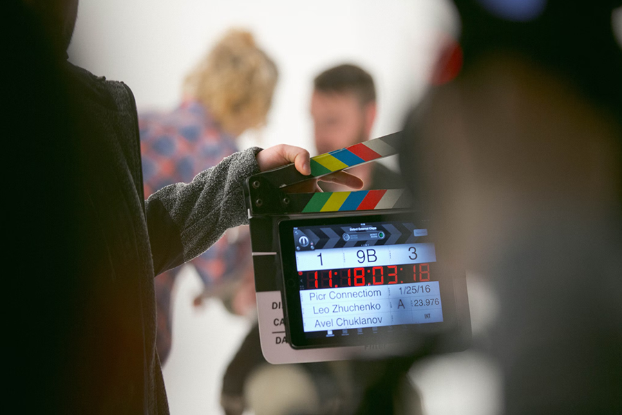 person holding an electronic clapperboard