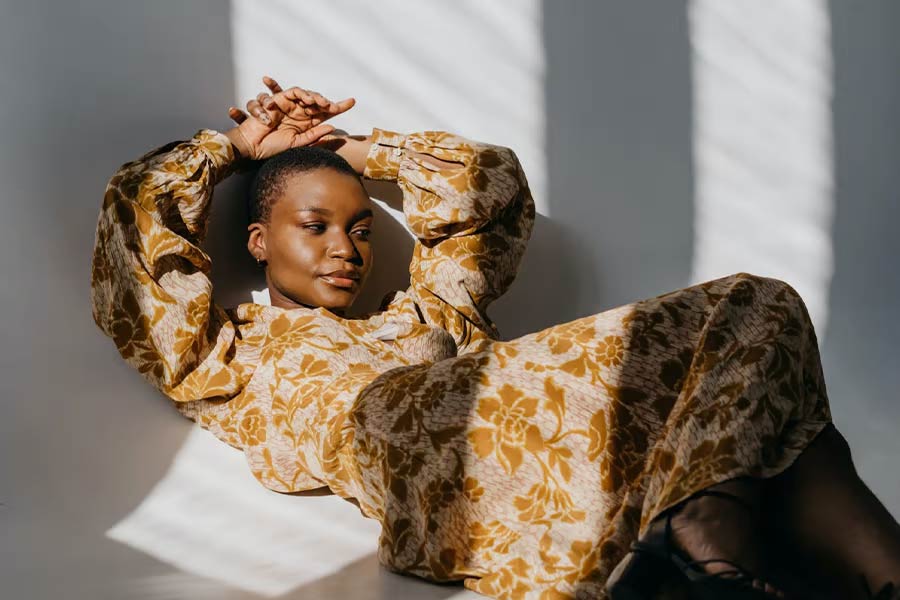 Woman lying down in floral dress