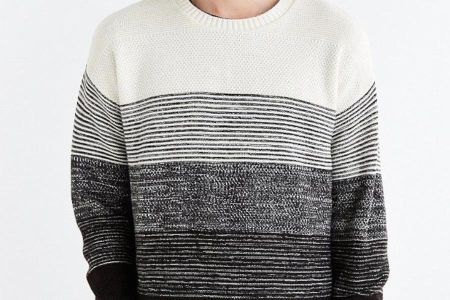 A man wearing a monochrome crew neck sweater