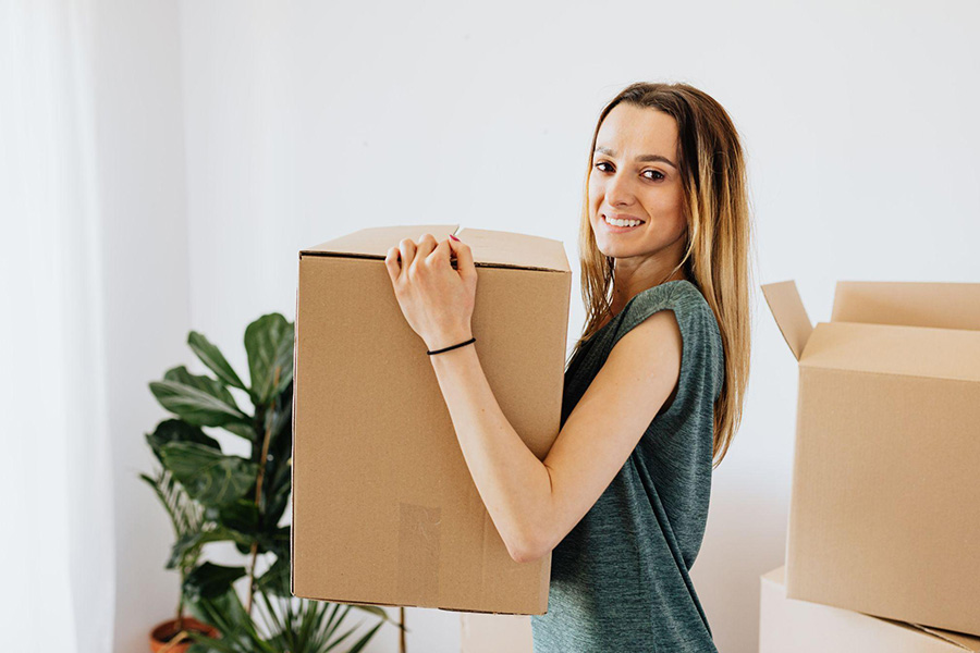 A woman carrying a box