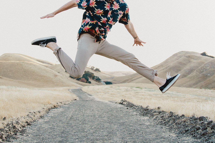 A young man in a shirt and chino pants