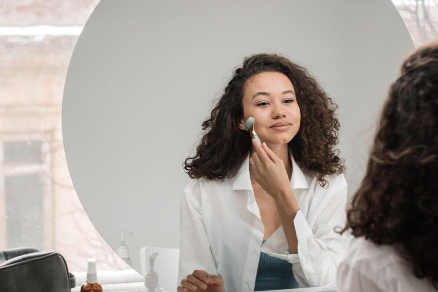 A young woman massaging her face