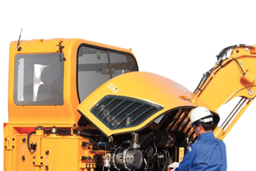 Engineer maintaining excavator engine