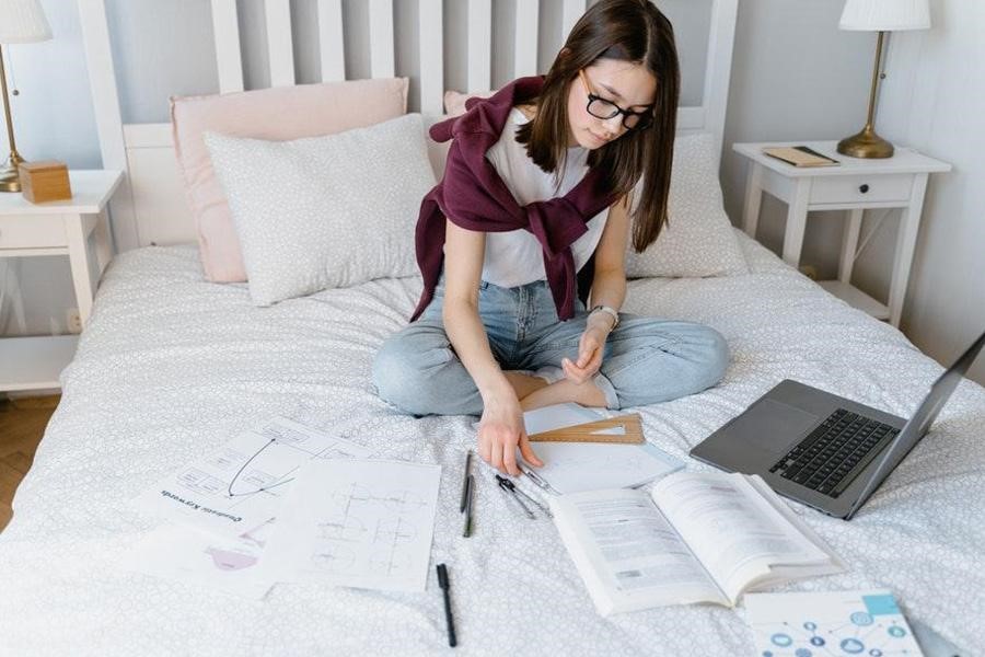 Lady in white top and red sweater checking accounts