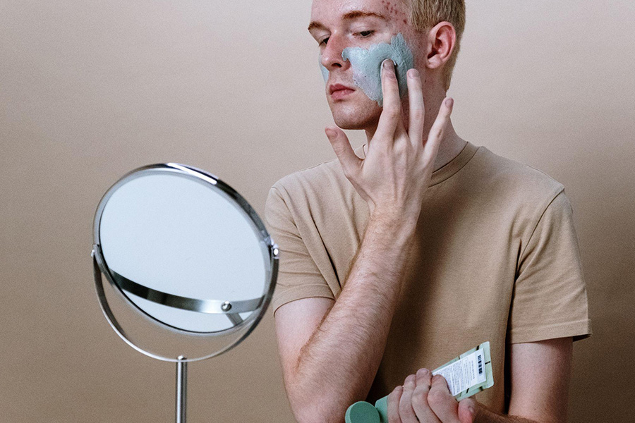 Man applying balm to sensitive skin