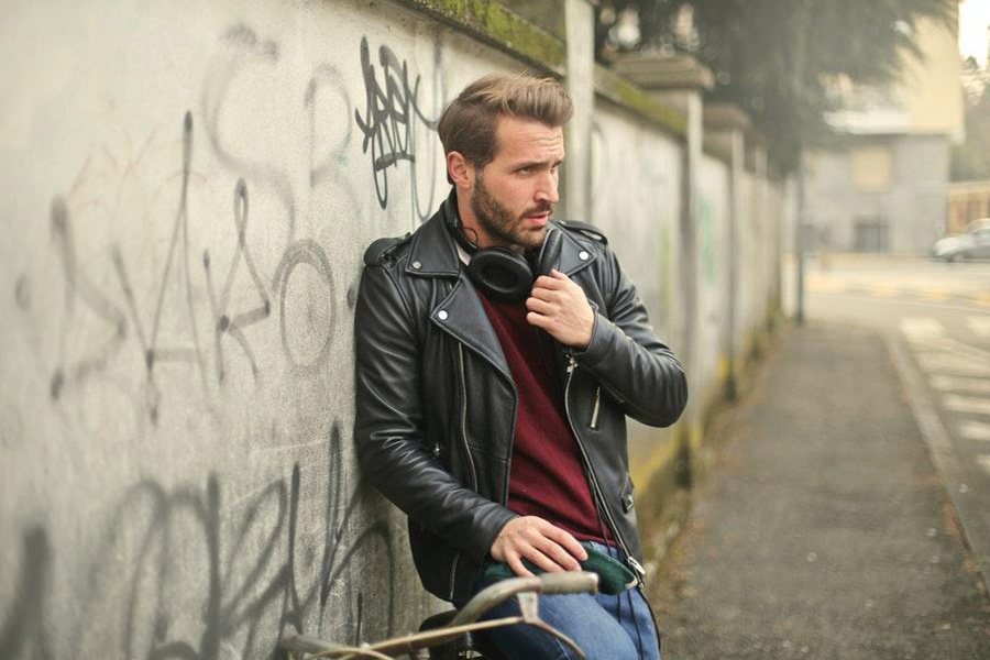 Man rocking a black aviator jacket over a red top