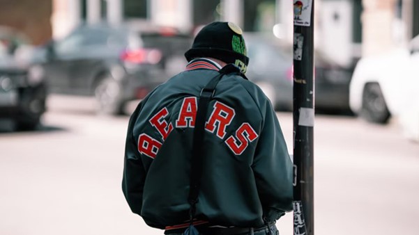 Person Wearing A Black And Red Varsity Jacket