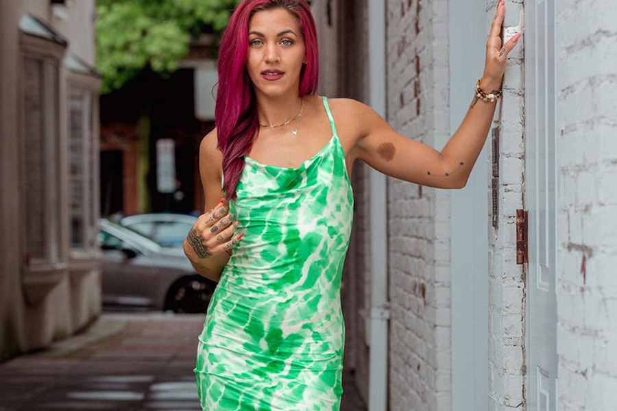 Red-hait lady rocking a green tie-dye short dress