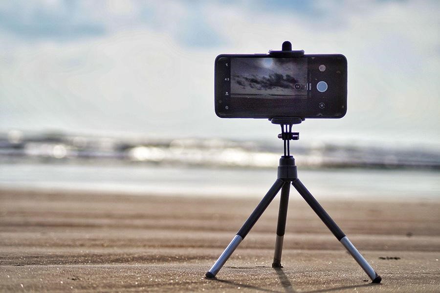 Smartphone mounted on a mini tripod