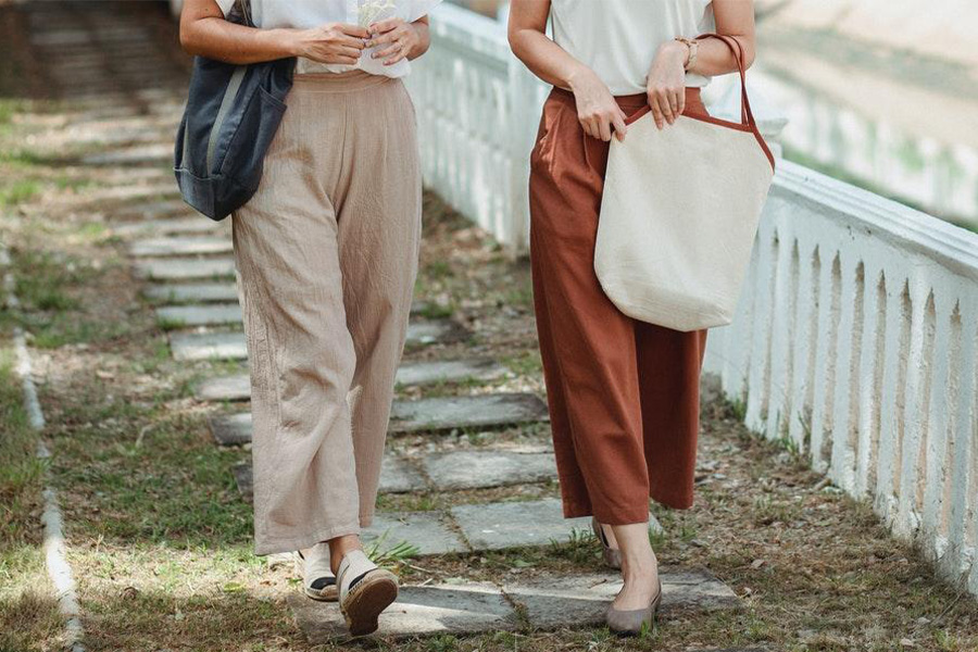 Two faceless women rocking wide leg pants