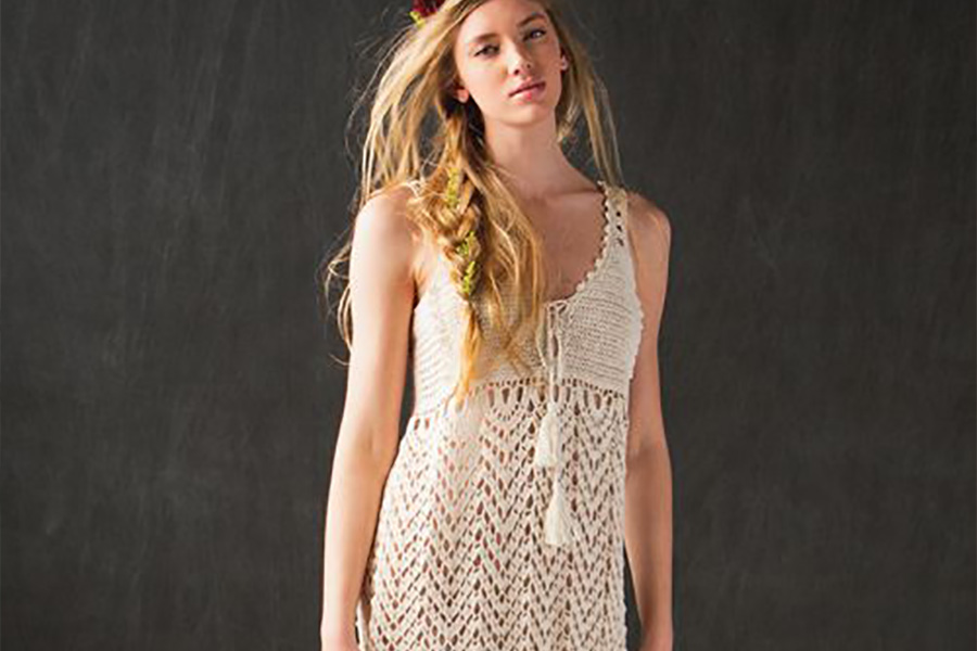 Woman Rocking Cream Colored Crochet Empire Waist Dress