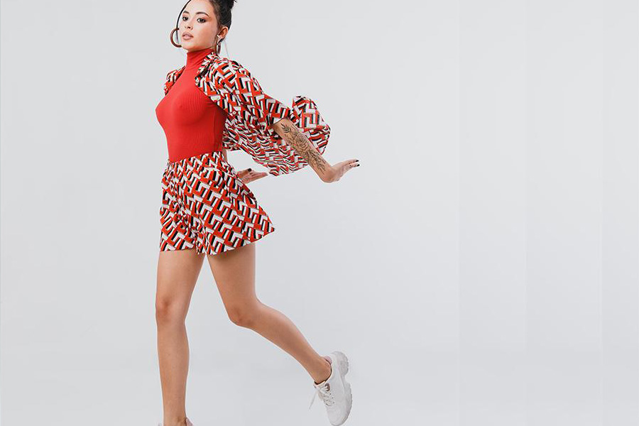 Young lady striking a pose in short shorts and shirt