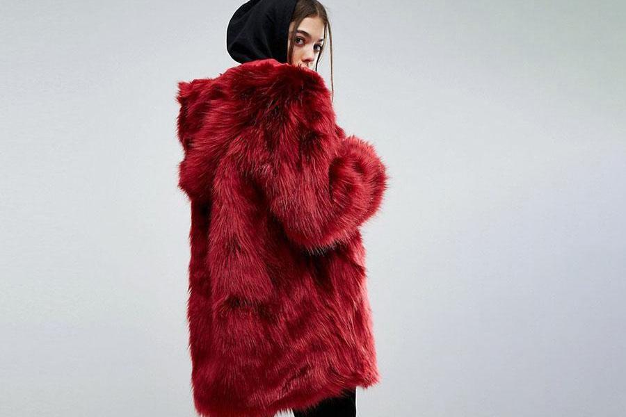 A woman in a red plush fur coat