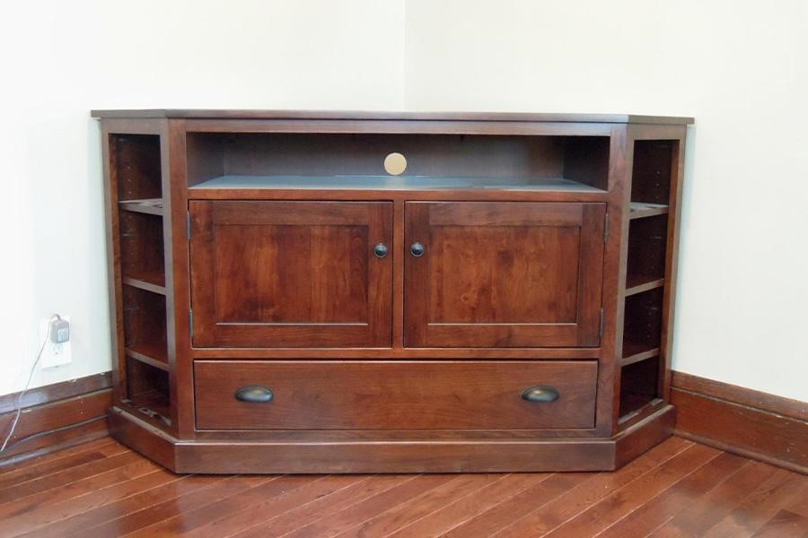 A wooden corner TV stand