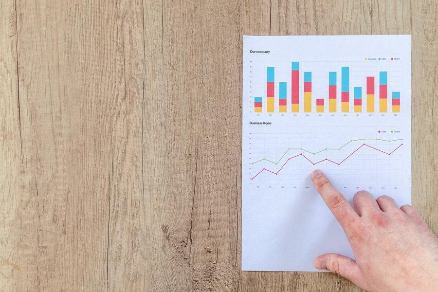 Anonymous hand showing business growth statistics