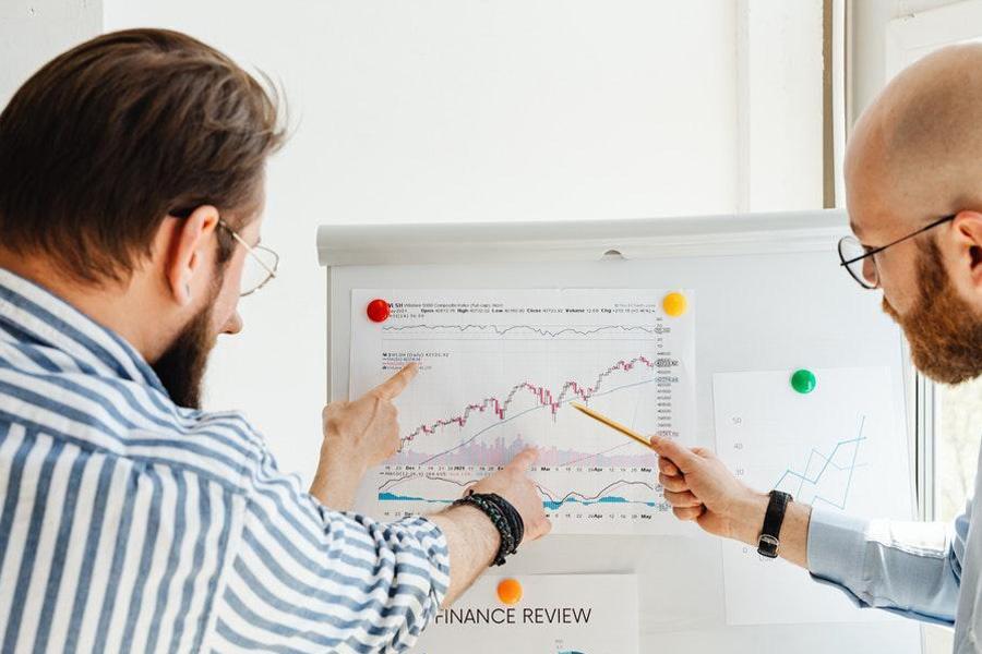 Business Men performing business analysis on a board