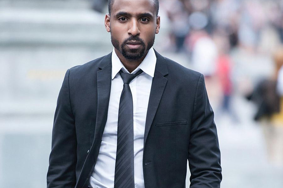 Man rocking a black single-breasted suit