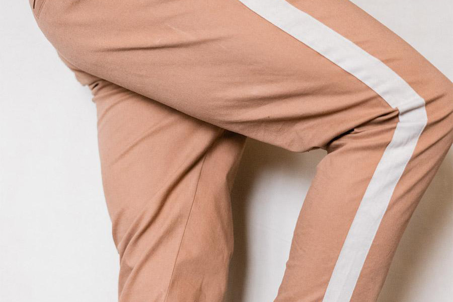 Man rocking beige and white side-stripe pants