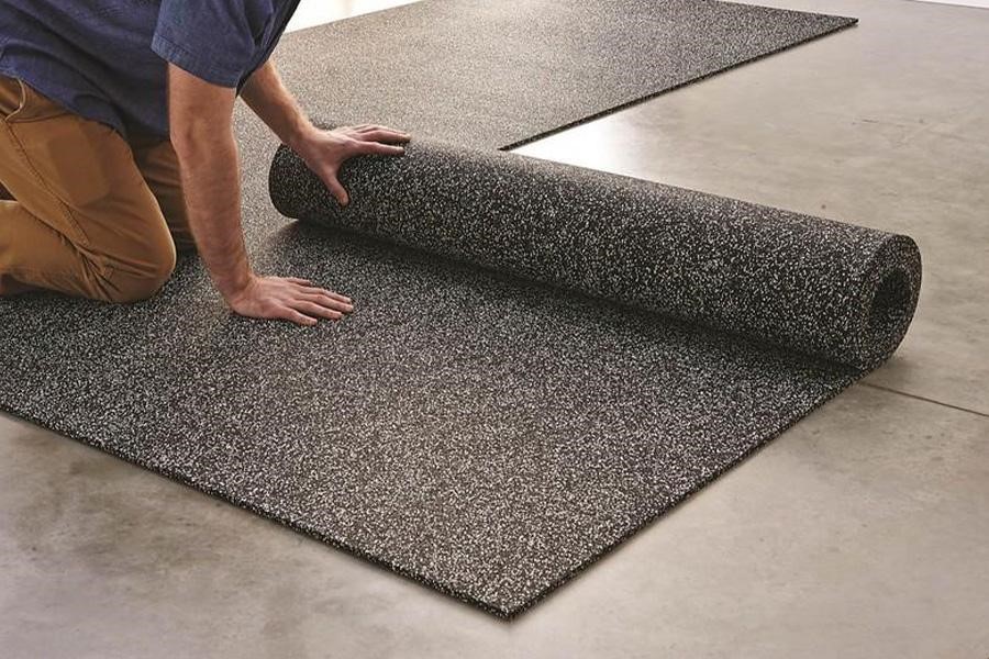 Man rolling a rubber mat