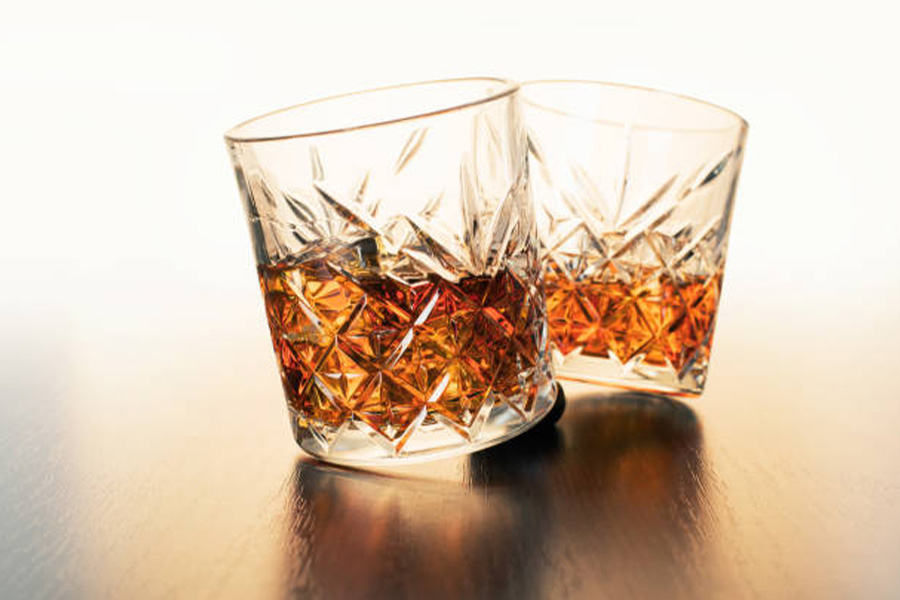 Two old fashioned glass cups rotating on table