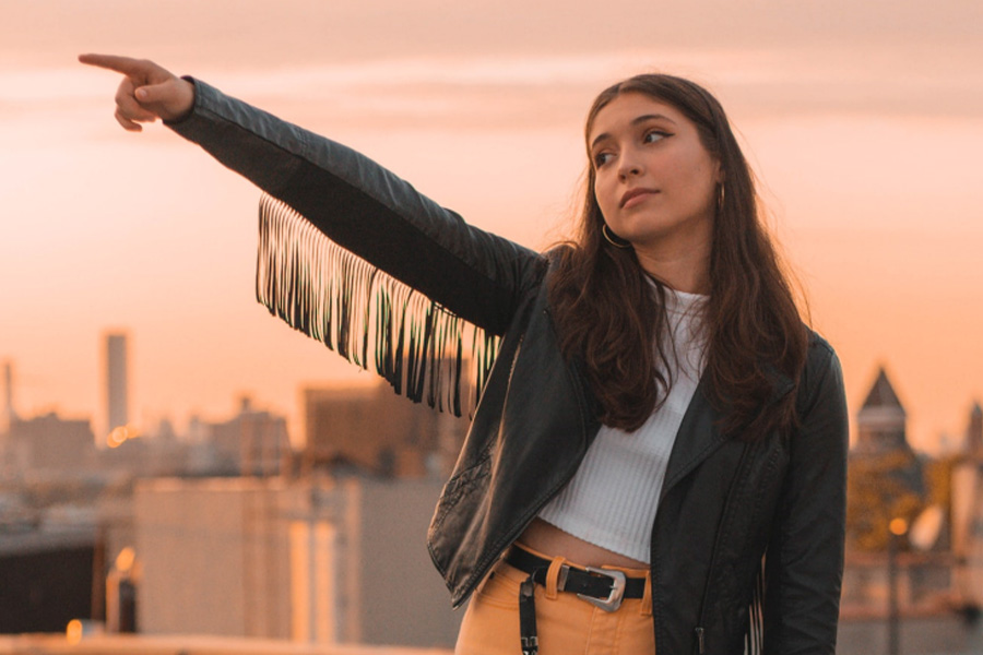 Woman in black leather jacket with fringes