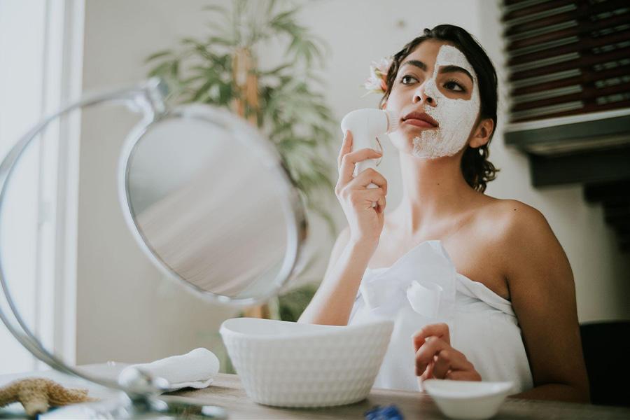 Woman using a facial cleansing brush