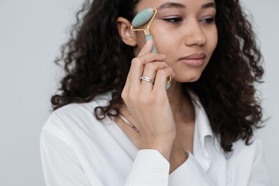 Woman using a jade roller