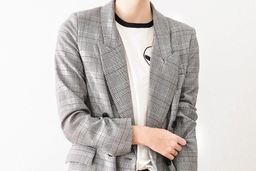 Woman wearing gray plaid blazer