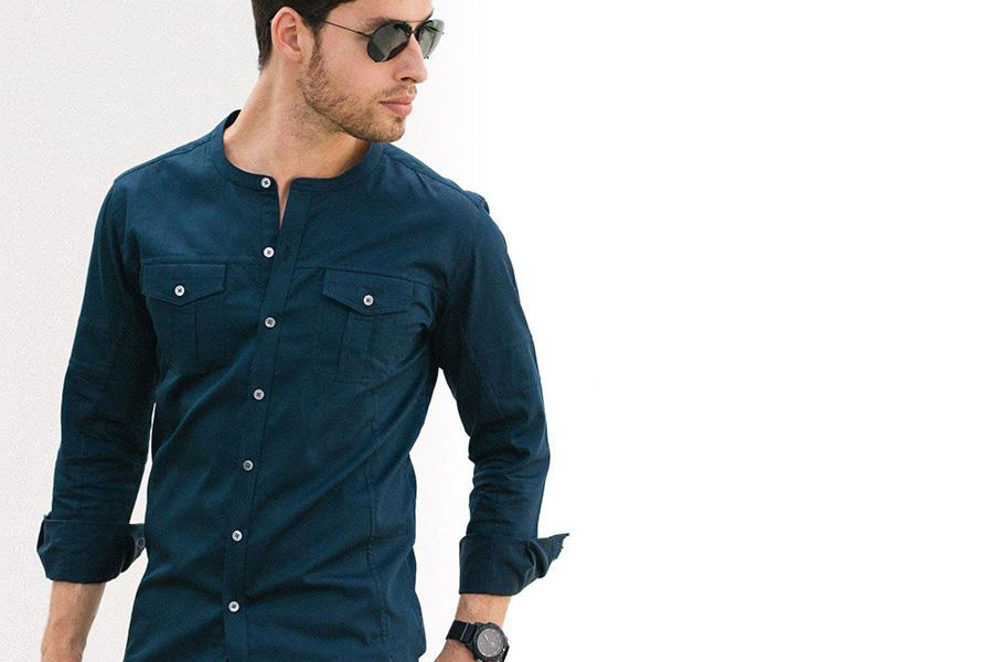 Young man posing in a dark blue western shirt