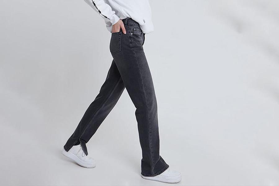 Young man wearing a trouser with split hems at ankles