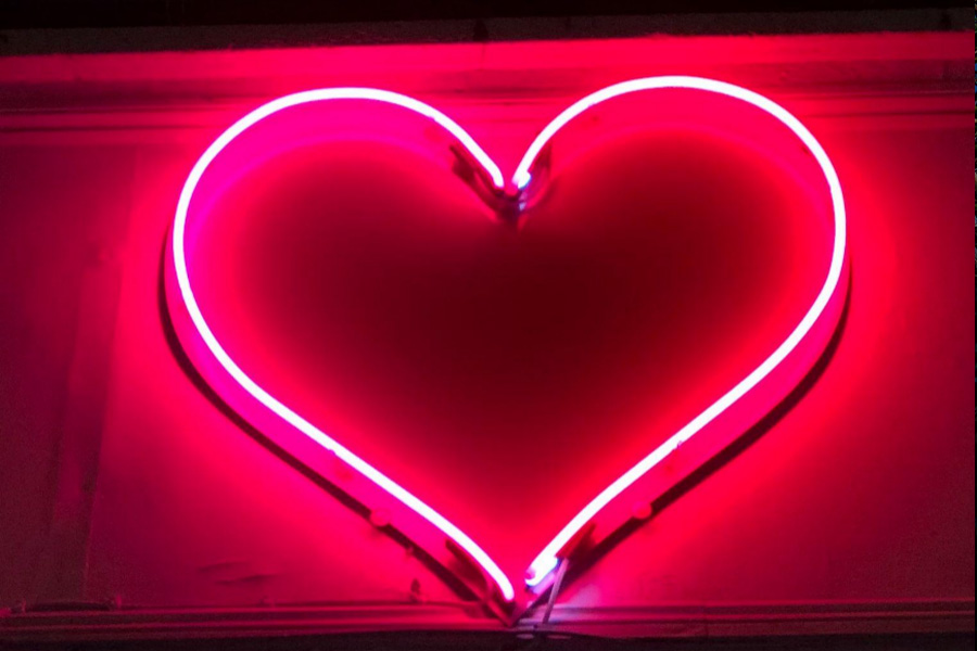 A heart-shaped neon LED sign