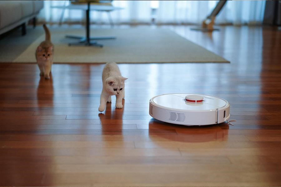 A white robot vacuum cleaner 