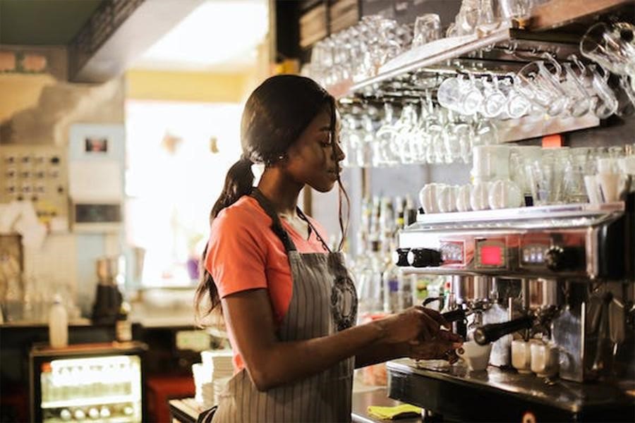 An attendant operating a beverage machine