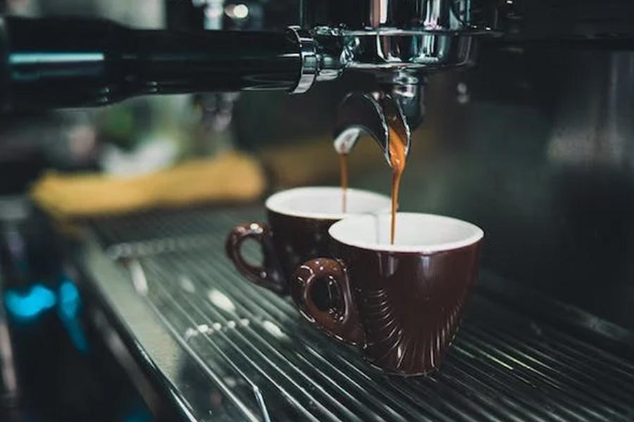 Black espresso maker at work